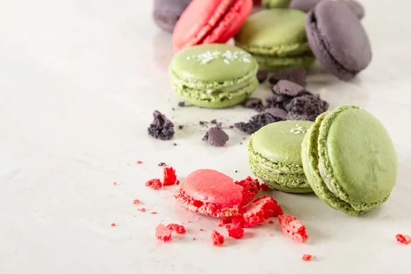 French dessert macaroons with pistachios and strawberries. White background