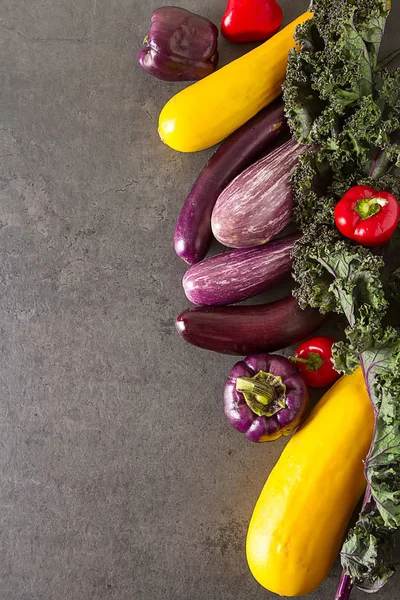 Small eggplants, yellow zucchini, tomatoes, kale and purple pepp — Stock Photo, Image