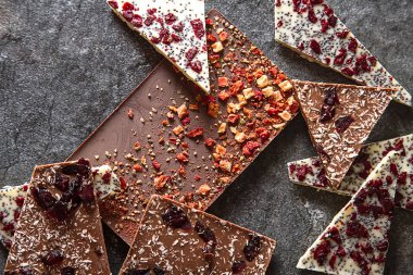 Beyaz, sütlü, koyu çikolata çilek ile. Koyu arka plan.