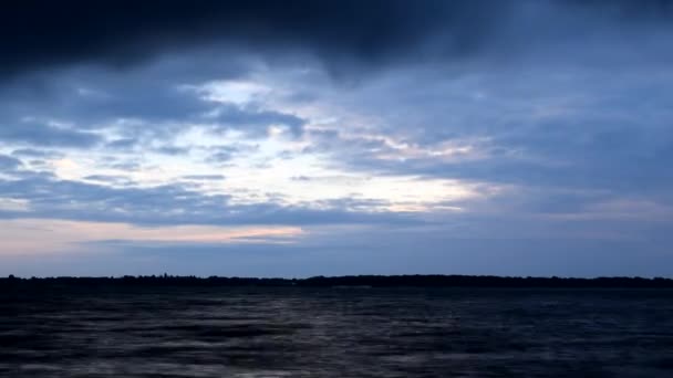 Schöne blaue Wolken ziehen im Morgengrauen schnell über das Wasser — Stockvideo