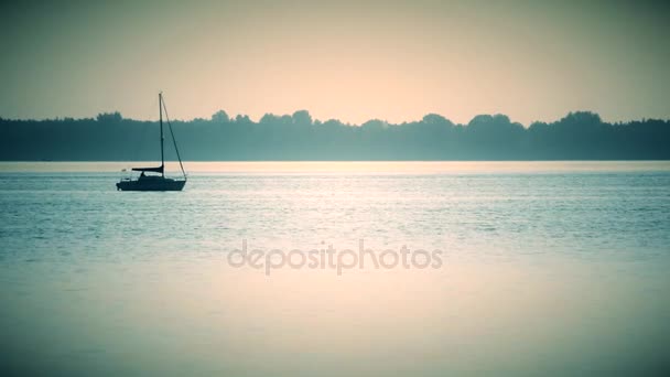 Sail boat far off on a lake or river — Stock Video