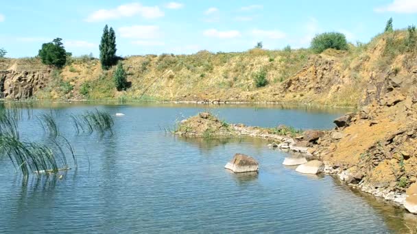 Beautiful landscape of lake in summer with basalt rocks, stones, calm water — Stock Video