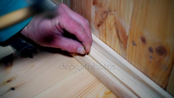 Male hands affixing a wooden skirting board — Stock Footage Male hands affixing a wooden skirting board Royalty Free Stock Footage