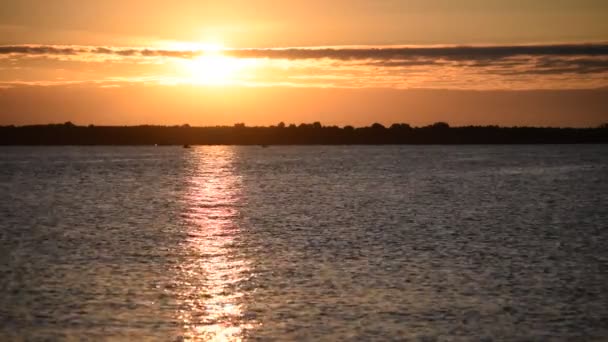 Sunrise over water with orange and yellow clouds — Stock Video