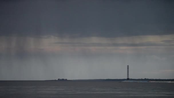 Stormy clouds mover over water with lighthouse — Stock Video