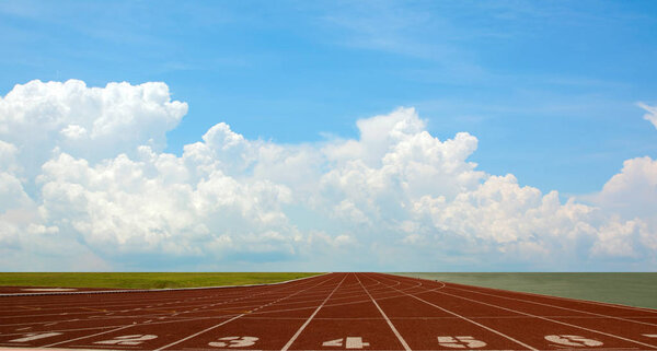Running track with the lanes over sky and clouds