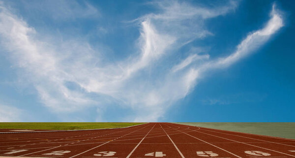 Running track with the lanes over sky and clouds
