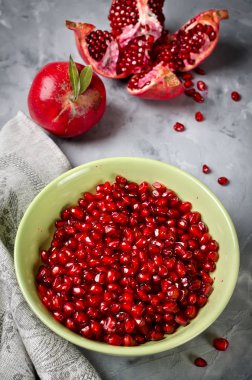 Gri beton zemin üzerine kırmızı olgun nar