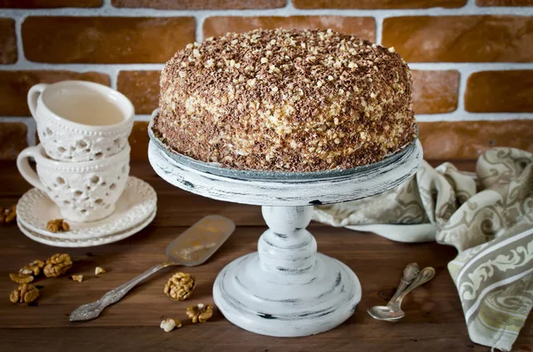 Honey cake with walnuts and grated chocolate — Stock Photo, Image