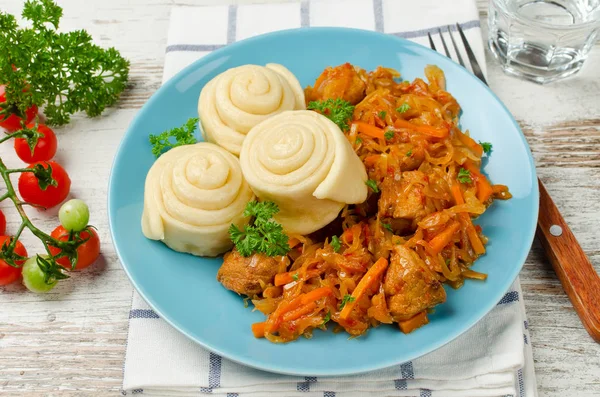 Cabbage stew with buns cooked in a steamer