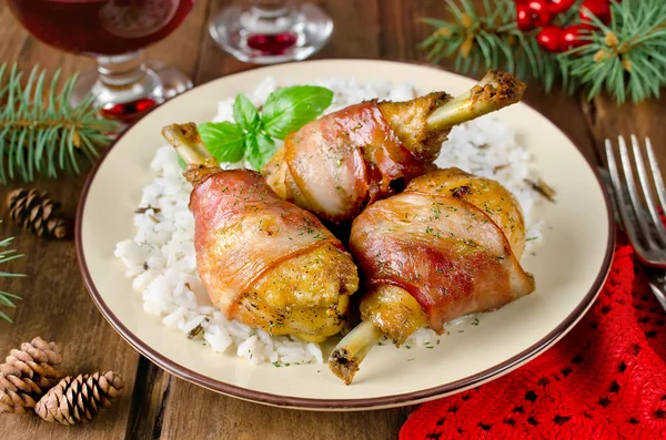Bacon wrapped chicken legs with rice garnish