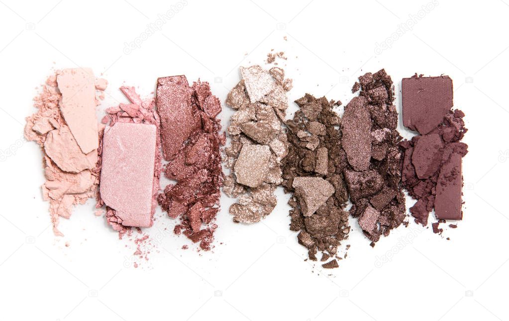 A smashed, neutral toned eyeshadow make up palette isolated on a white background