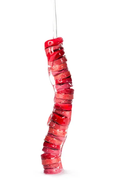 Montón de lápices labiales hidratantes en rodajas con aceite nutritivo, vertiendo sobre ellos — Foto de Stock