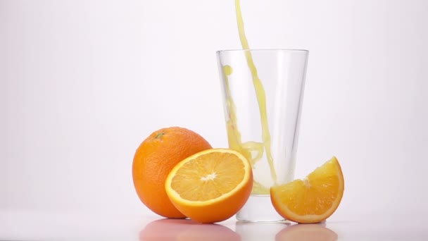 Выливание апельсинового сока в стекло. — стоковое видео