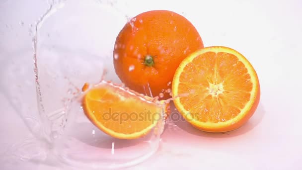 Кусочки апельсина падают на стол . — стоковое видео