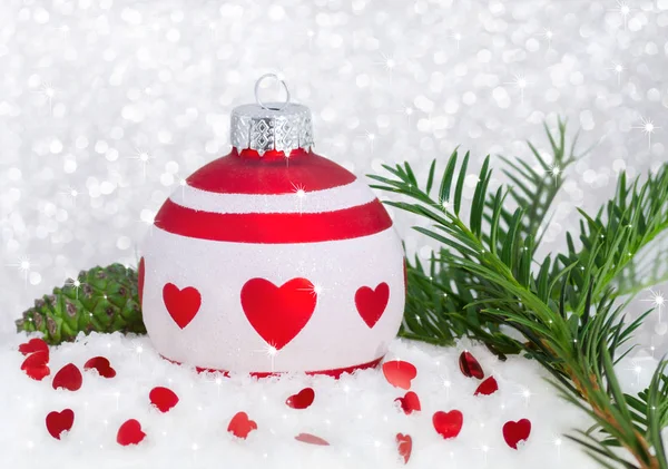 Christmas card happy new year with red white bauble, hearts, tree, snow, cone and light bokeh — Stock Photo, Image