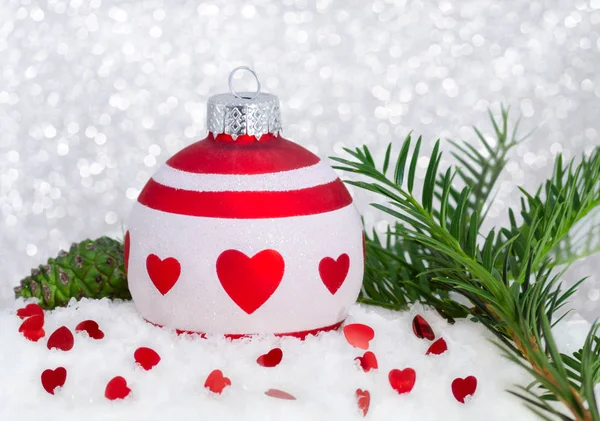 Happy new year with red white christmas bauble, hearts, tree, snow, cone and bokeh — Stock Photo, Image