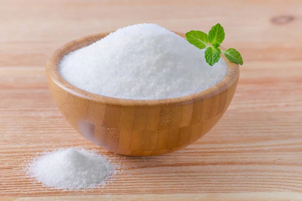 Birch sugar xylitol in a wood bowl with mint on wooden — Stock Photo, Image