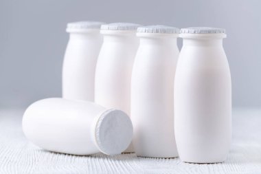 içki yoğurt gri arka plan üzerinde plastik şişelerde