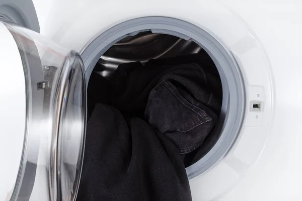 Washing black clothes, open wash machine closeup — Stock Photo, Image