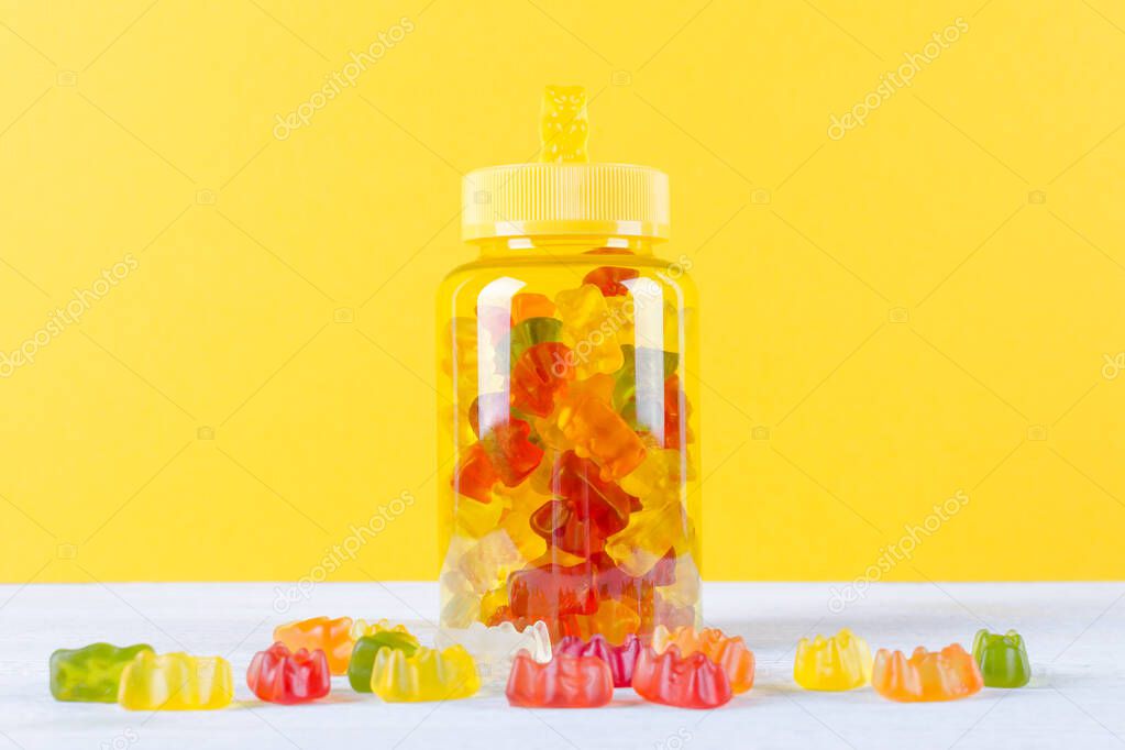 vitamins for children like jelly candy on yellow background