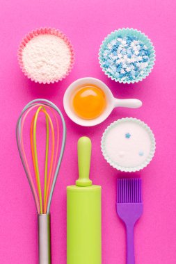 Pembe arka planda pişirme ve mutfak aletleri için malzemeler