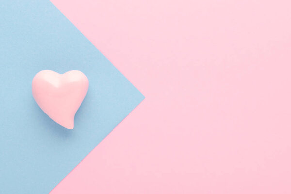 pastel pink background with a heart and copy space, soft focus