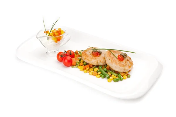 The dietary fish cutlets served with a garnish from corn and asparagus haricot. — ストック写真