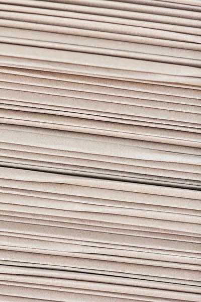 Background from the sheets of a cardboard put by a pile.