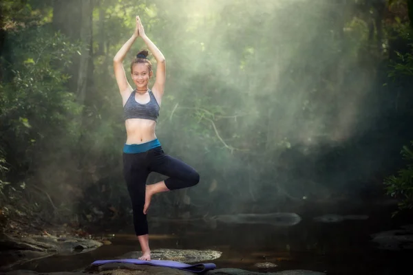 YOGA Women Yoga  practicing yoga and relaxing in forest nature