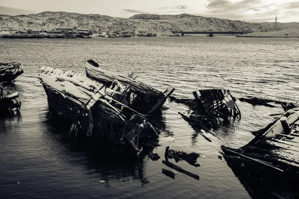 Sunken ships near the snowy coast in Teriberka, Murmansk Region, Russia ...