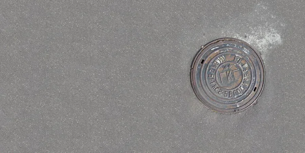 Pavement top view. Pavement texture. Background of old cobblestone pavement close-up. Pavement road stone. Texture of the modern street architecture. View from above. Round Manhole Cover Utility Shaft