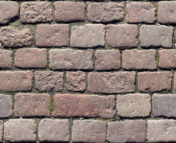 Stone pavement texture. Granite cobblestoned pavement background. Abstract background of old cobblestone pavement close-up. Seamless texture. Perfect tiled on all sides