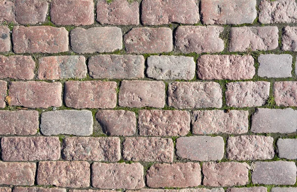 Stone pavement texture. Granite cobblestoned pavement background. Abstract background of old cobblestone pavement close-up. Seamless texture. Perfect tiled on all sides