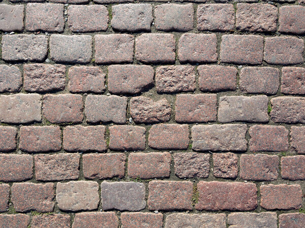 Stone pavement texture. Granite cobblestoned pavement