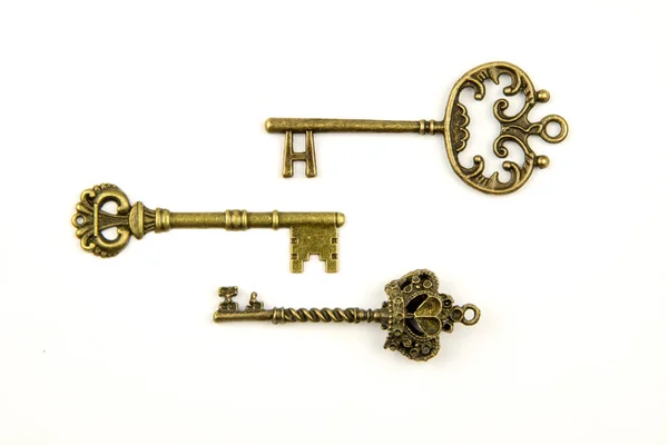 Prydnads medeltida vintage nycklar med intrikata består smide, av fleur-de-lis element, viktorianska bladet rullar och hjärtformade virvlar. antika gyllene dörren nyckel isolerad på vit bakgrund — Stockfoto