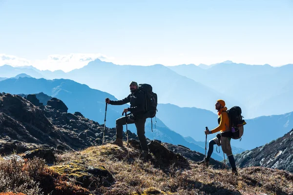 朝の山の景色の前に 2 つのハイカーのシルエット — ストック写真