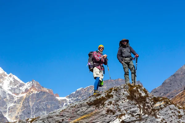 Hikers staying on high Rock — Stock Photo, Image
