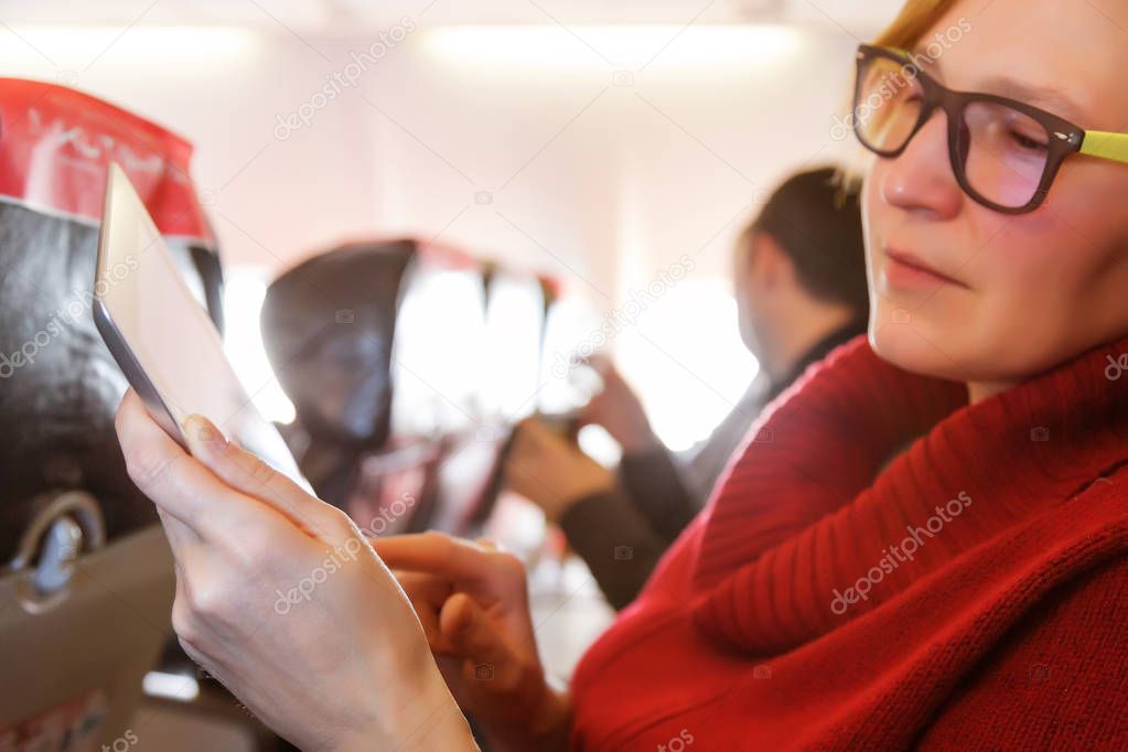 Female Passenger using Tablet 