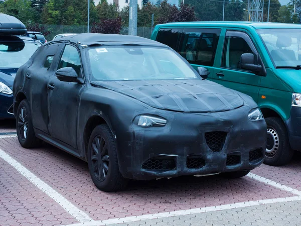 Oulx, Italy _ October  01, 2016 Prototype of a SUV car camouflaged testing on the road