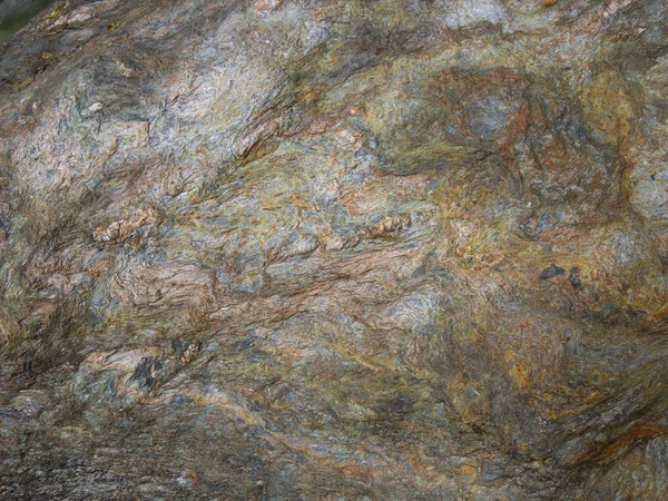 Close up of Metamorphic rocks with colorful mineral streaks.   T
