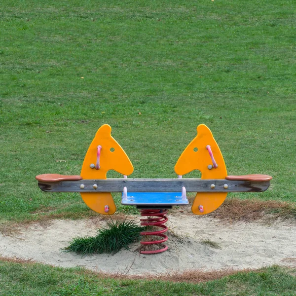 Double seats spring Horse in the meadow  of a Playground — Stock Photo, Image