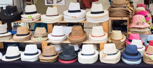Panamá y otros tipos de sombreros vendidos en un mercado callejero — Foto de Stock