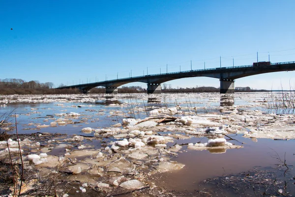 Ice drift on the river and the bridge