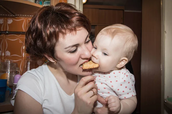 Mother and daughter eating cookies