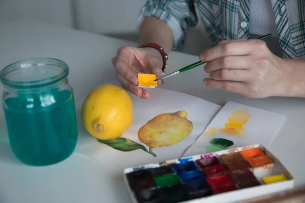 Female artist\'s hand on the table