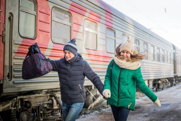 Couple is late for the train at railway station