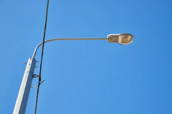 LED street lights on high steel pillars and blue sky