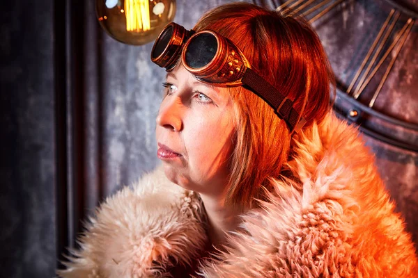 Ugly strange girl in unusual glasses in a strange dark room with a clock on the wall and the light of lamps. Cosplay photo shoot in the Studio. Apocalypse