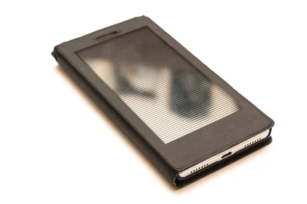 Teléfono móvil en estuche negro, aislado en blanco . — Foto de Stock